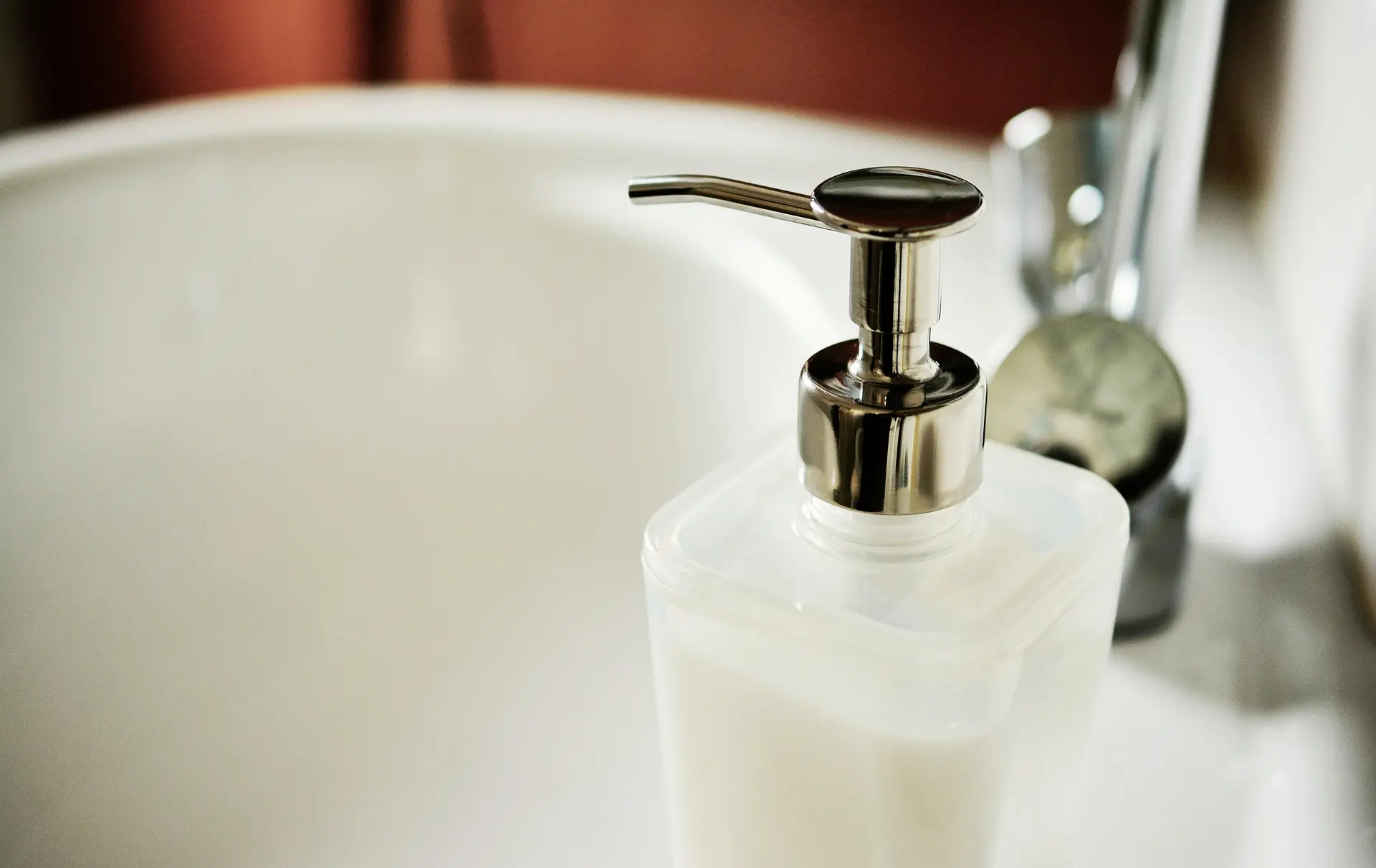 White wash basin with a clean white hand towel in a laundry facility