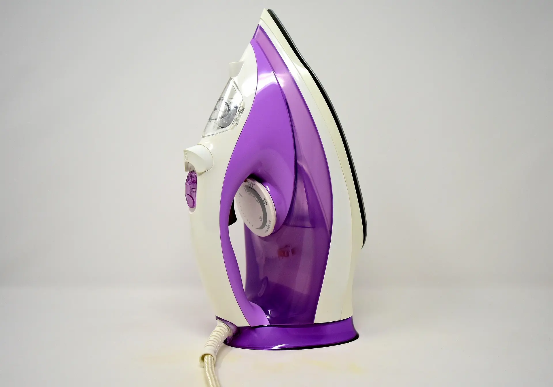 Purple-colored electric iron box used for professional clothes ironing