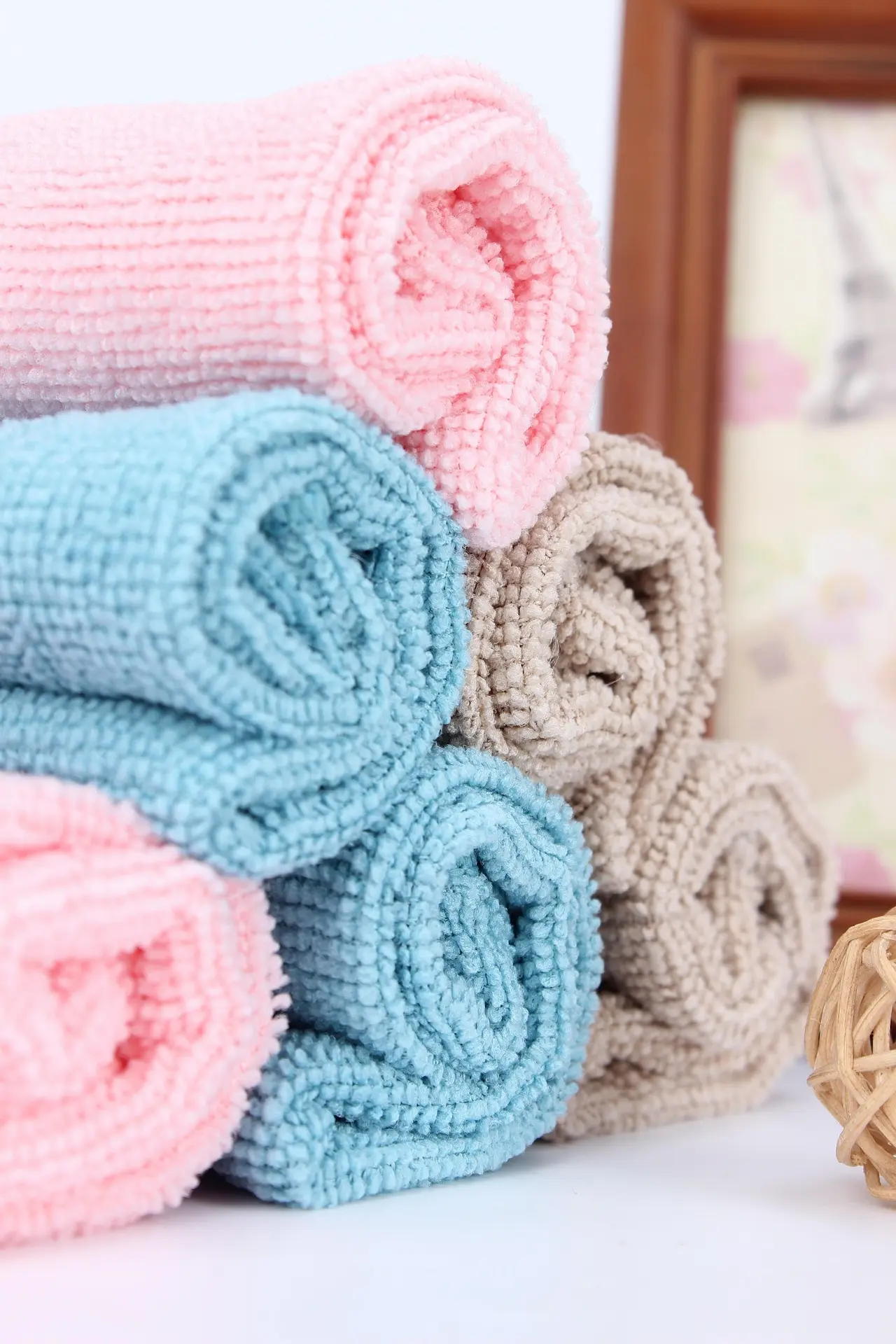 colorful towels rolled and neatly arranged in blue and pink shades